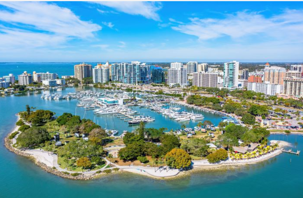 Sarasota marina at sunset — a seasonal Florida coastal town where snowbirds close up their homes for the summer