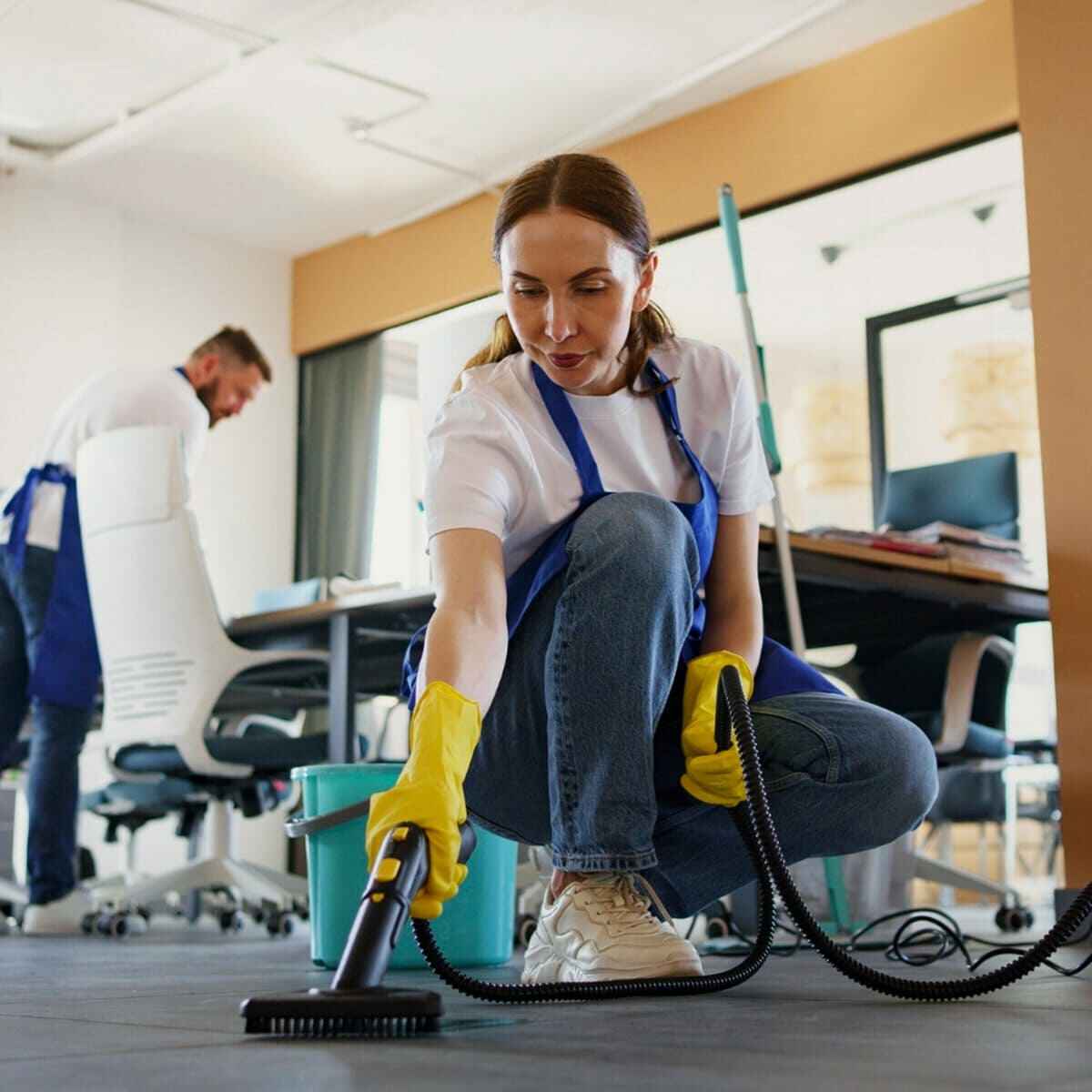 Cleaner detailing the edge of a kitchen counter during a deep clean